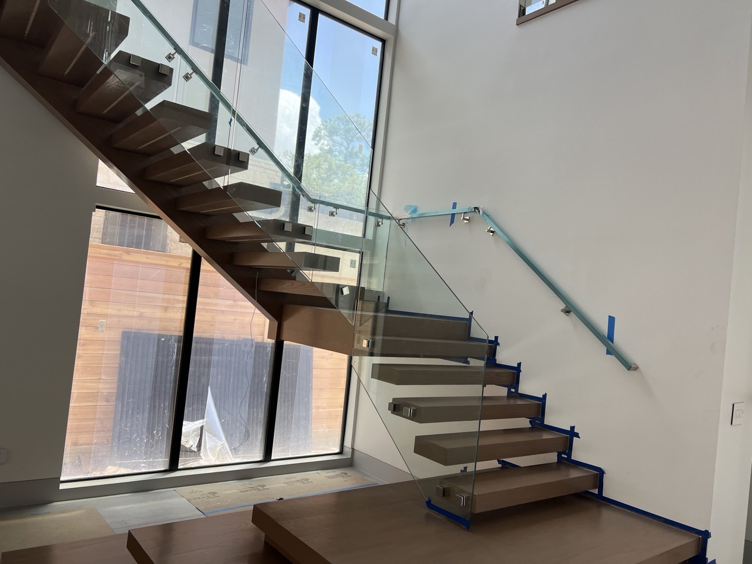 Floating wood staircase with glass railing